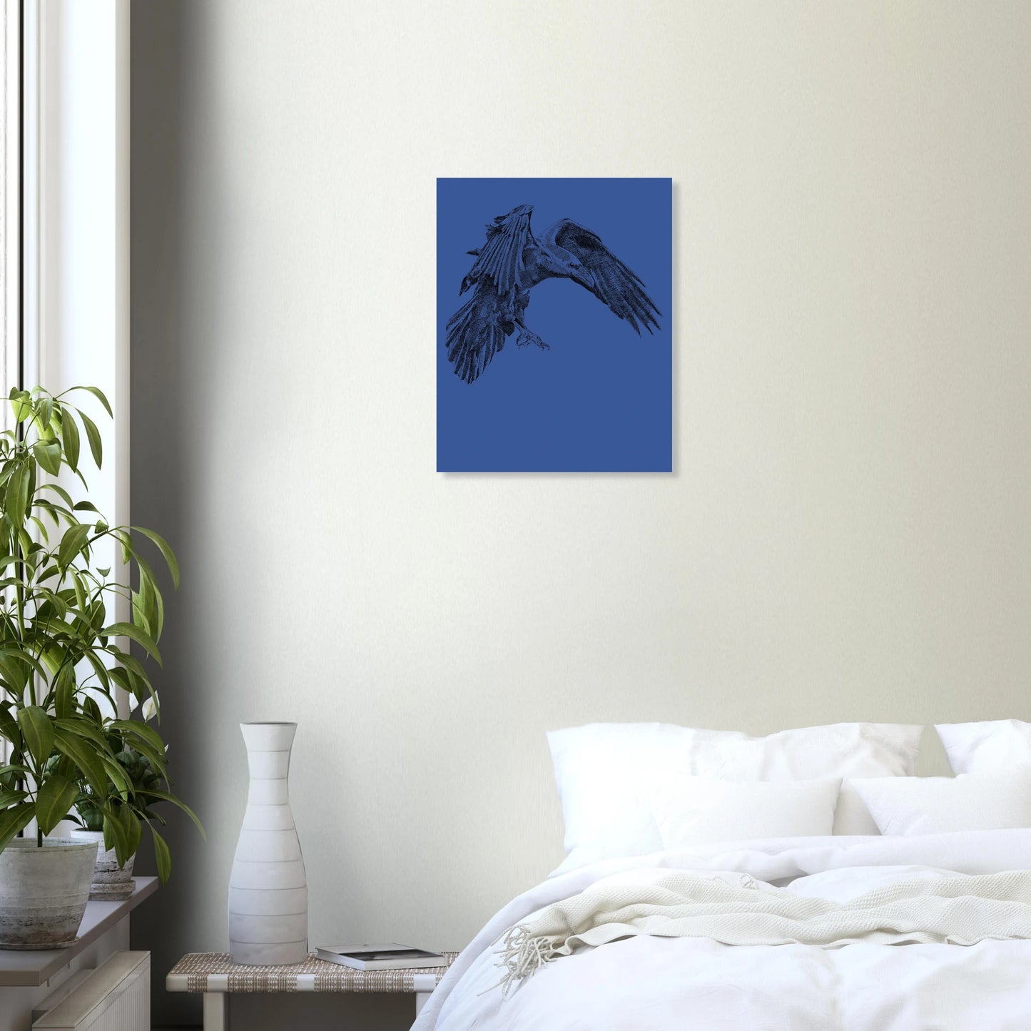 A line drawing print of a black crow on a blue background handing on the wall of a bedroom