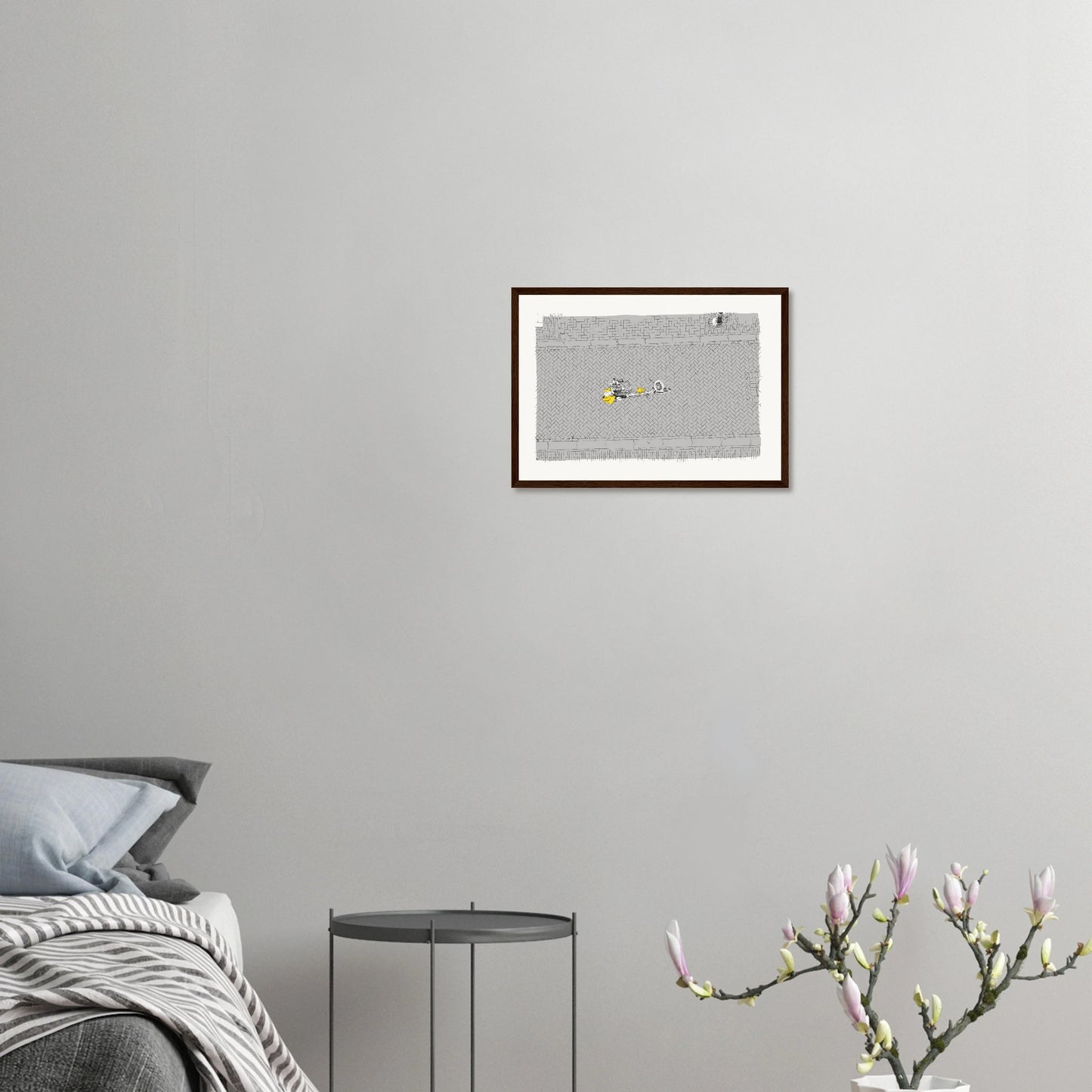 Birds' eye view of a single cyclist on the back of a tandem on a cobbled Amsterdam street. Black and white with the cyclist's coat highlighted in yellow