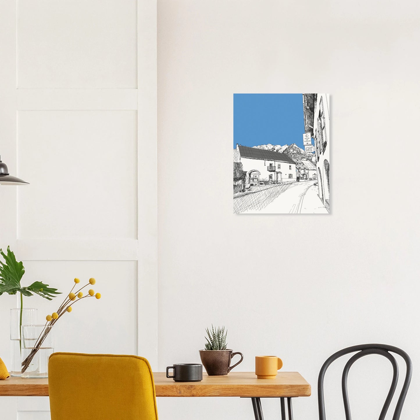 Black and white print of a line drawing of le monetier les bains with the sky highlighted in blue and mountains in the background